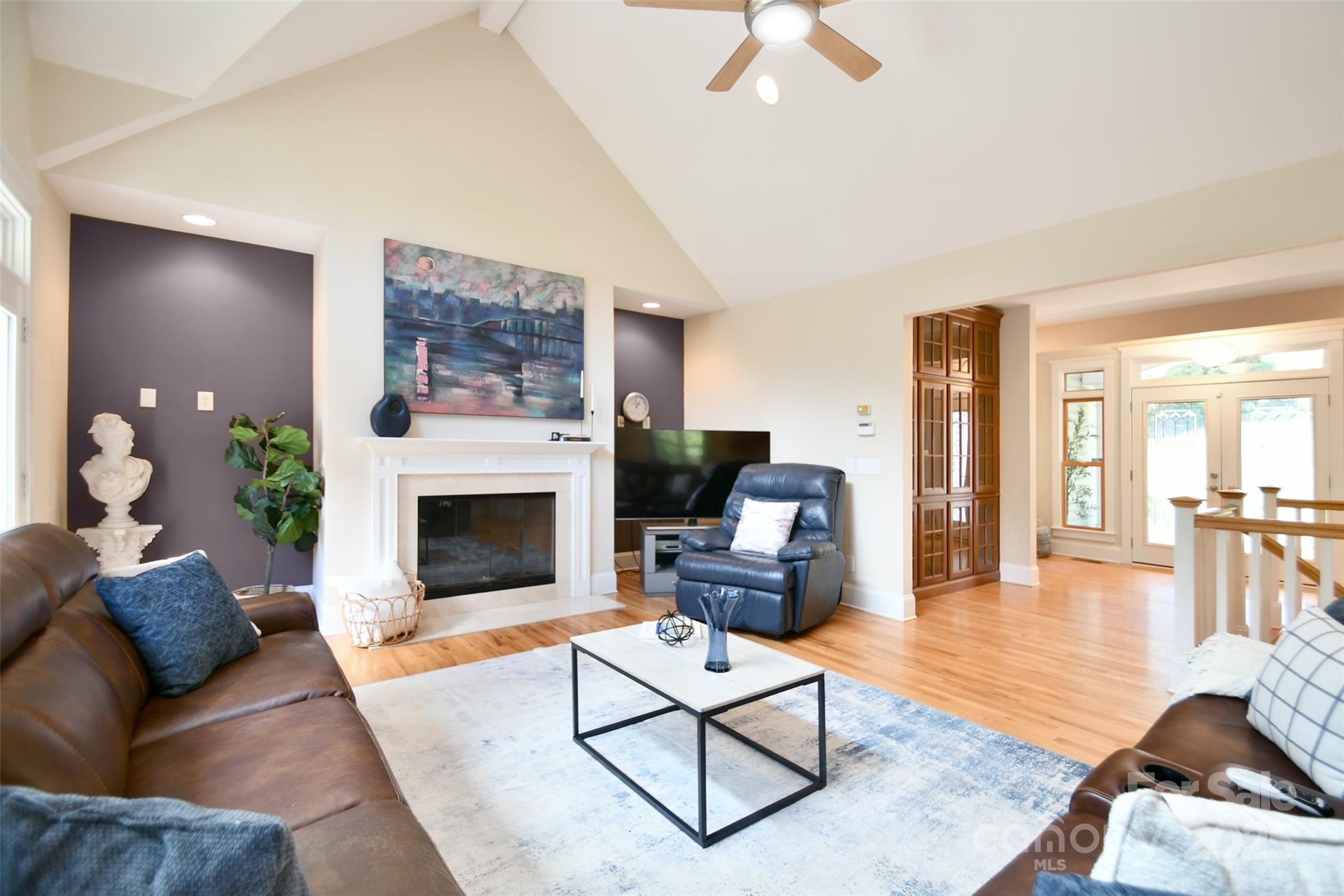 14832 Hus McGinnis Road Huntersville, NC 28078 - Photo 13 of 48 a living room with furniture a fireplace and a flat screen tv