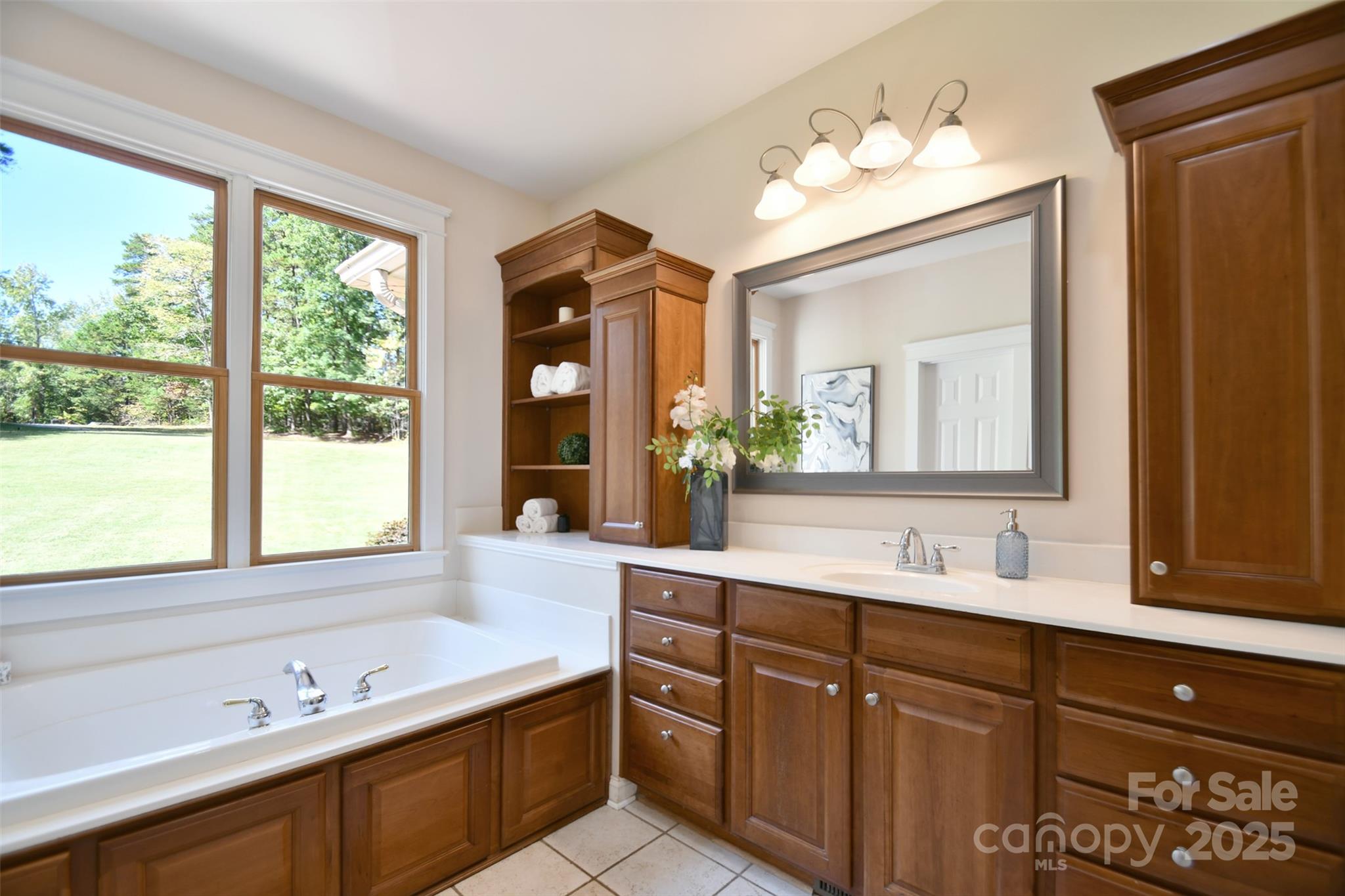 14832 Hus McGinnis Road Huntersville, NC 28078 - Photo 23 of 48 a spacious bathroom with double vanity a window a double vanity and a mirror