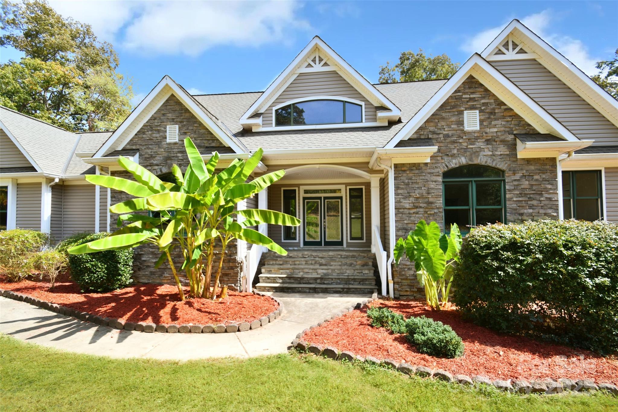 14832 Hus McGinnis Road Huntersville, NC 28078 - Photo 3 of 48 a front view of a house with a yard and potted plants