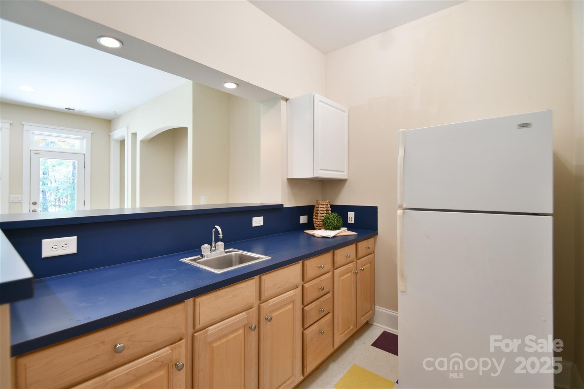 14832 Hus McGinnis Road Huntersville, NC 28078 - Photo 31 of 48 a kitchen with stainless steel appliances a refrigerator sink and cabinets