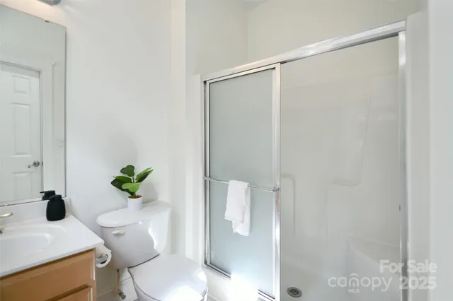 a white toilet sitting next to a bathroom sink