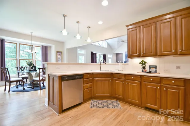 a kitchen with a sink cabinets and wooden floor