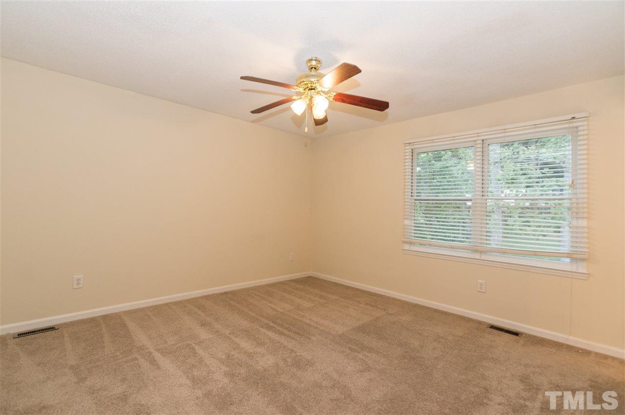 6812 Glendower Road Raleigh, NC 27613 - Photo 10 of 23 an empty room with windows and fan