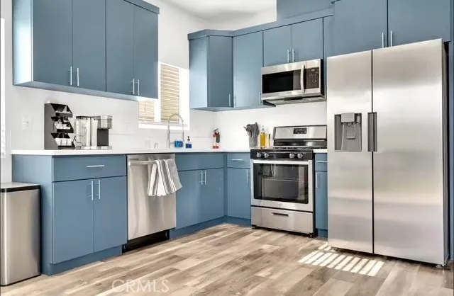 a kitchen with a refrigerator stove and microwave