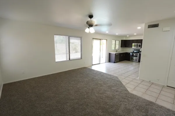 an empty room with windows and cabinet