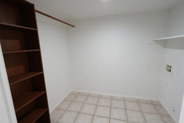 a view of walk in closet with empty racks