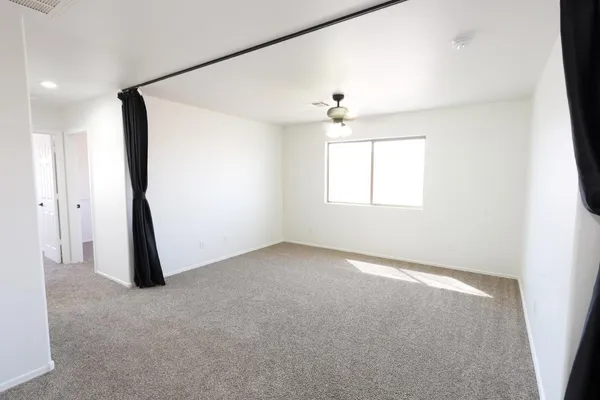 an empty room with windows and closet