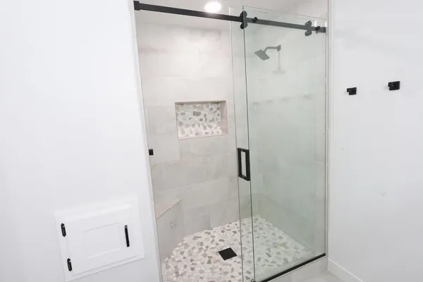 a bathroom with a glass shower door