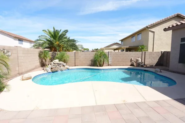 a view of a backyard house and swimming pool
