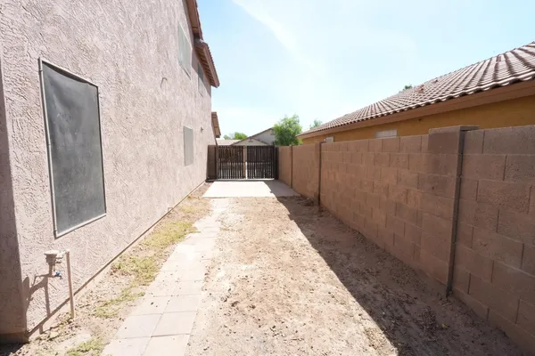 a view of a backyard with pathway