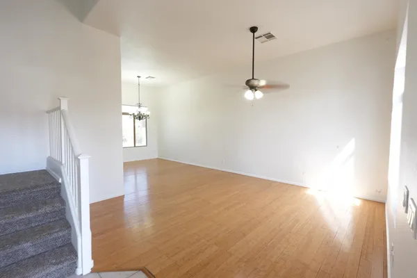 a view of a room with wooden floor and window