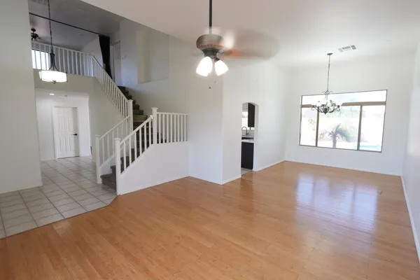 a view of empty room with wooden floor
