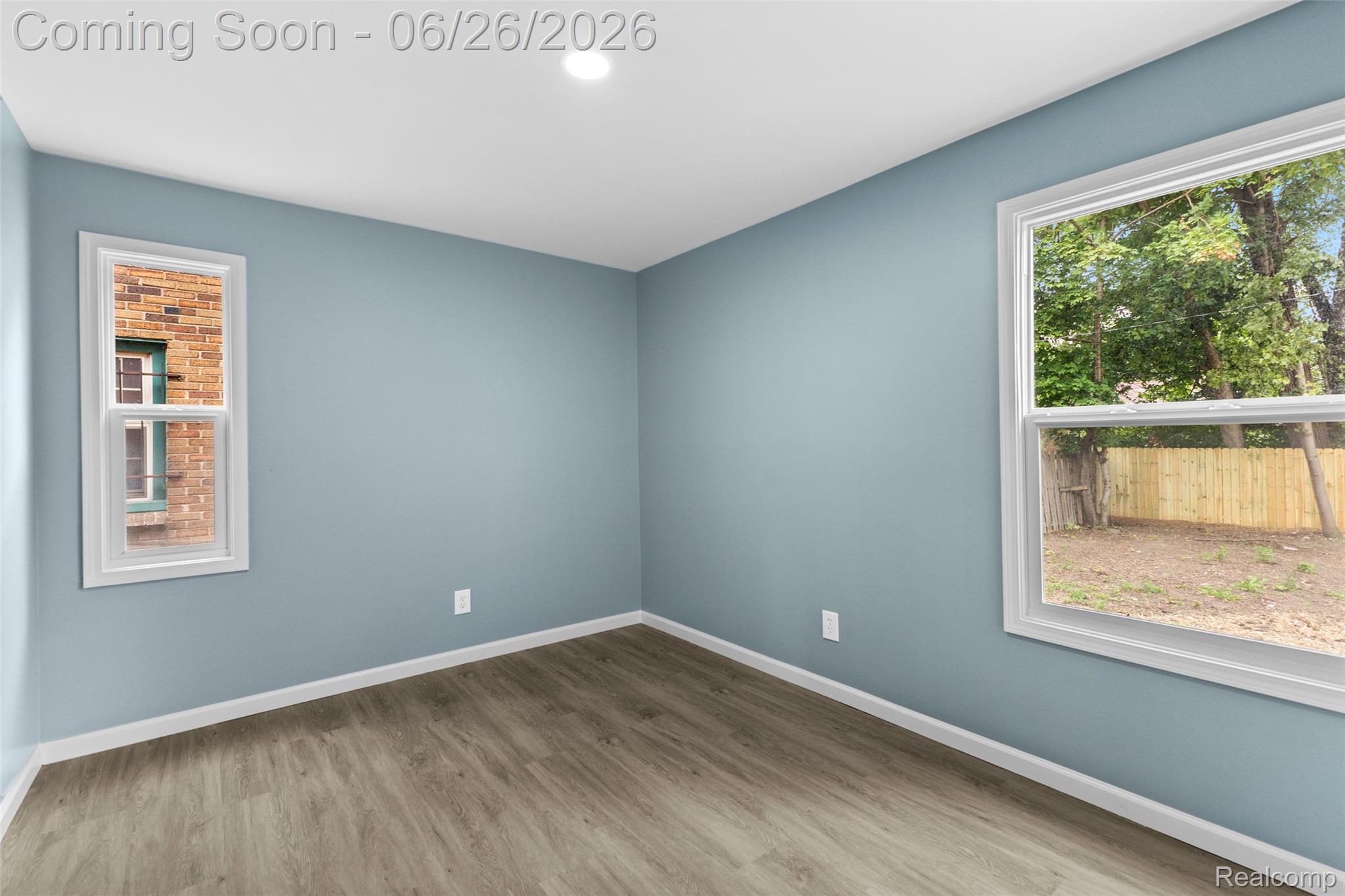 8310 Whitcomb Detroit, MI 48228 - Photo 20 of 26 Light blue walls with white trim, wood-finish flooring, recessed lighting, and two windows
