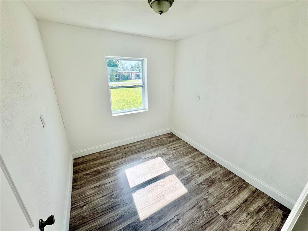 23476 Harper Avenue Punta Gorda, FL 33980 - Photo 16 of 19 a view of wooden floor and windows in a room