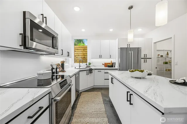 a kitchen with a sink stove and microwave