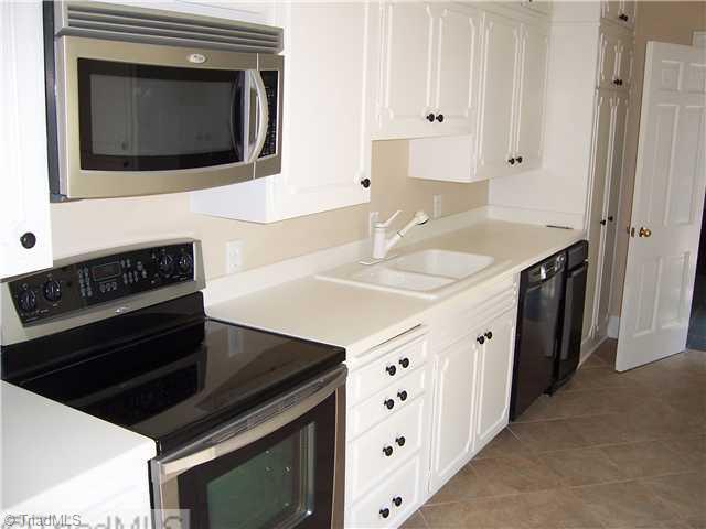 235 Cascade Drive High Point, NC 27265 - Photo 3 of 13 Kitchen. Galley style kitchen has lots of storage space. Recently updated. Tile floor.
