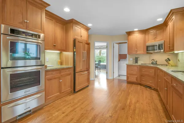 a kitchen with stainless steel appliances a stove a refrigerator and a microwave
