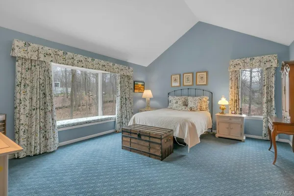 a spacious bedroom with a bed and a window