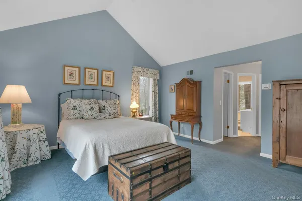a bedroom with bed and a chandelier