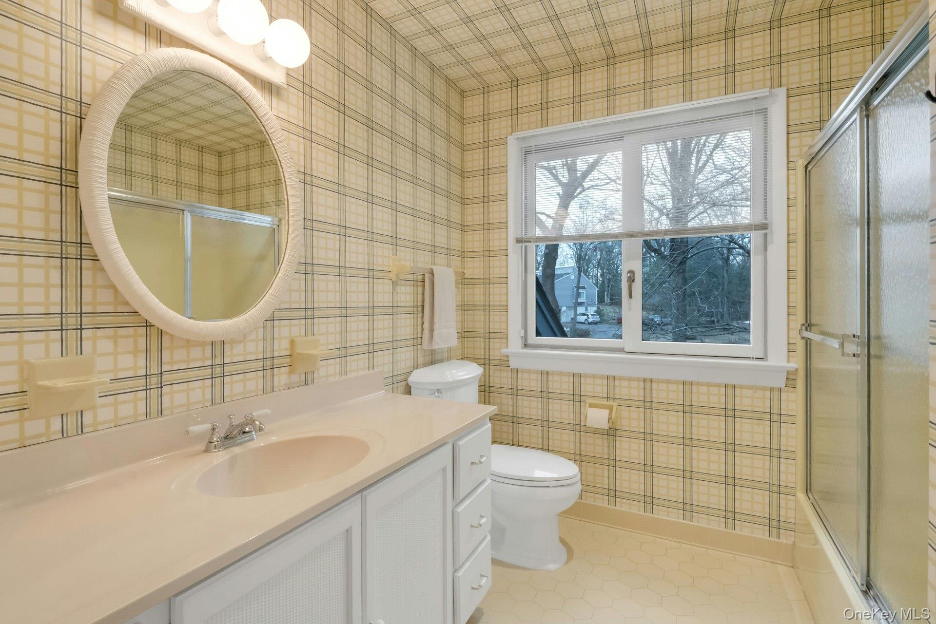 121 Law Road Briarcliff Manor, NY 10510 - Photo 32 of 48 Hall Bathroom on upstairs bedroom level with glass door shower/bathtub and wide sink vanity.