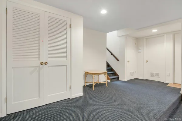 a view of an empty room with stairs