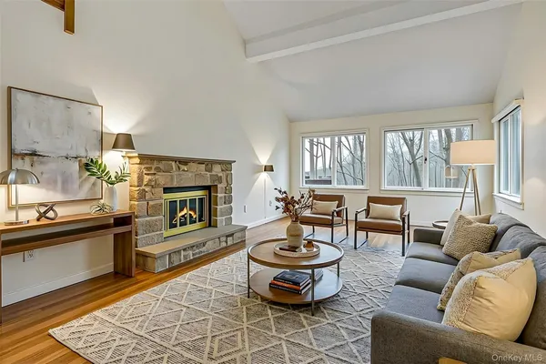 a living room with furniture a fireplace and a table