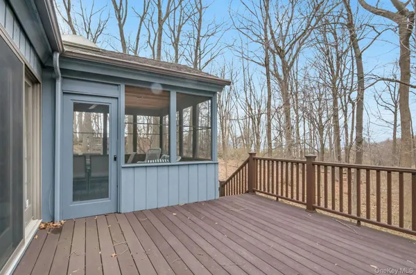 a view of backyard with a deck and wooden floor