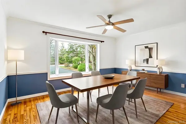 a view of a dining room with furniture and a window