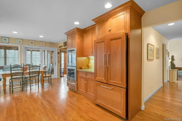 a view of a kitchen with furniture and wooden floor