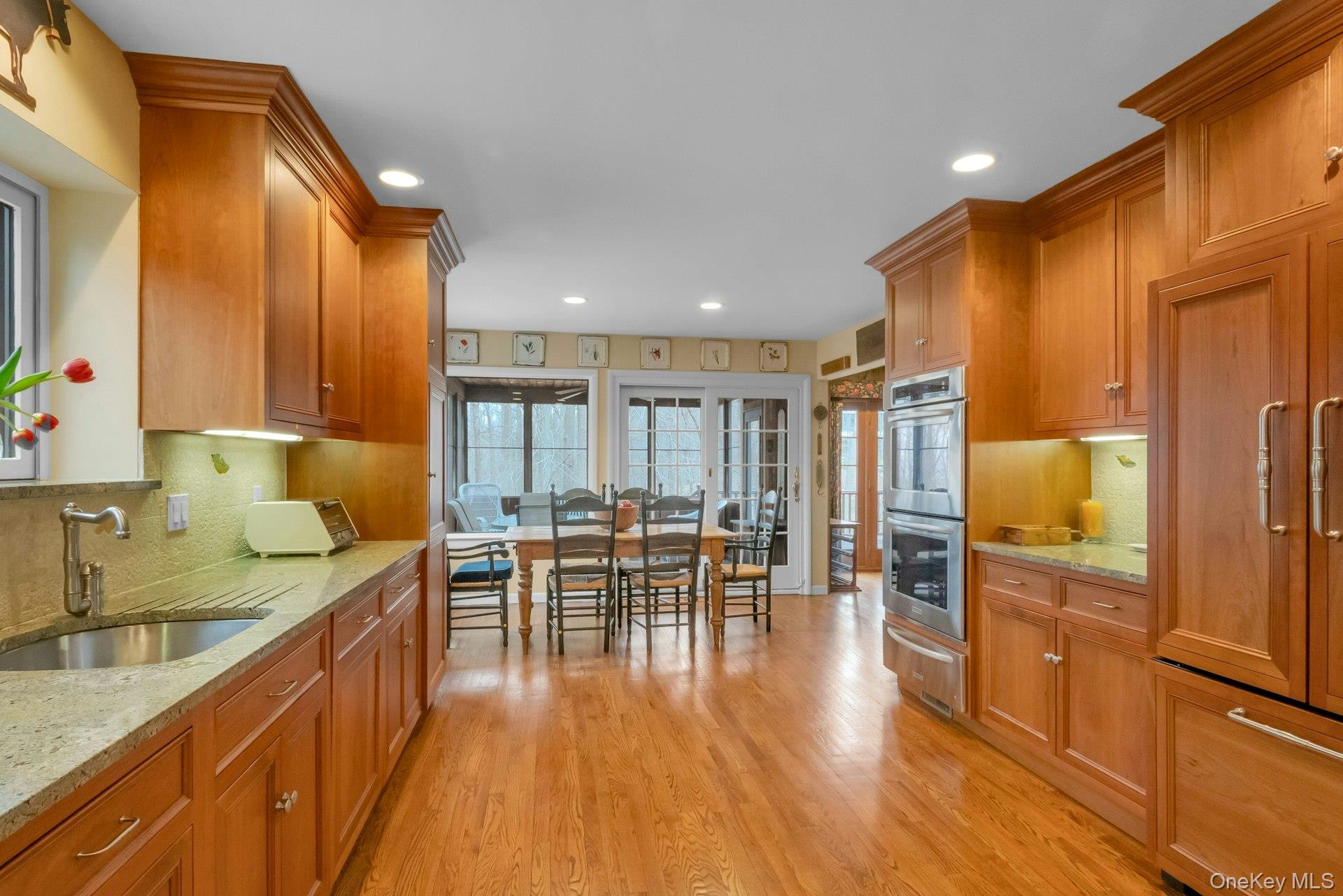 121 Law Road Briarcliff Manor, NY 10510 - Photo 10 of 48 Straight-on view of the EIK with a view to the Breakfast Area and into the Screened Porch beyond.