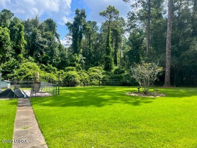 6285 Forsyth Road Macon, GA 31210 - Photo 21 of 24 a view of a swimming pool with a garden