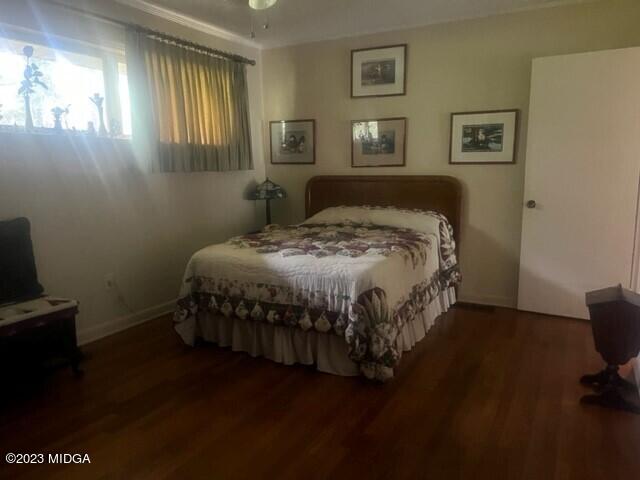 6285 Forsyth Road Macon, GA 31210 - Photo 23 of 24 a bedroom with a bed wooden floor and window