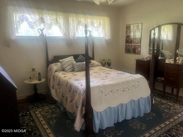 6285 Forsyth Road Macon, GA 31210 - Photo 7 of 24 a bed sitting in a bedroom next to a window