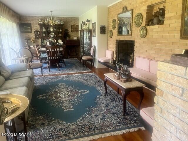 6285 Forsyth Road Macon, GA 31210 - Photo 8 of 24 a living room filled with furniture hardwood floor and a fireplace