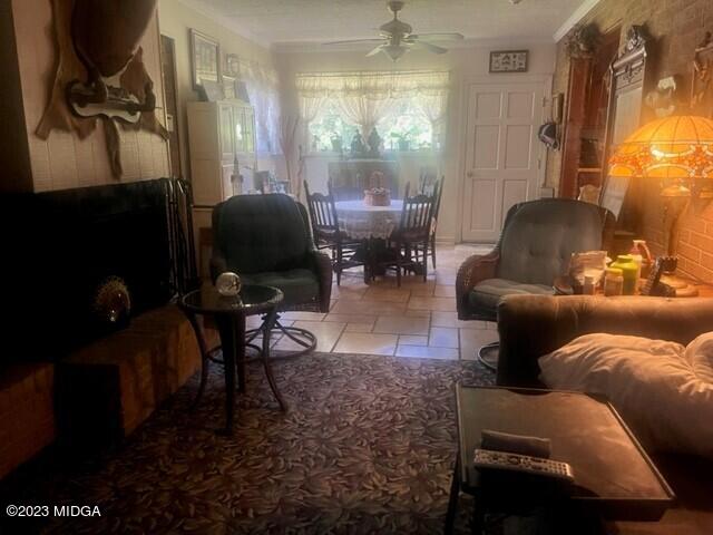 6285 Forsyth Road Macon, GA 31210 - Photo 10 of 24 a living room with furniture and a chandelier