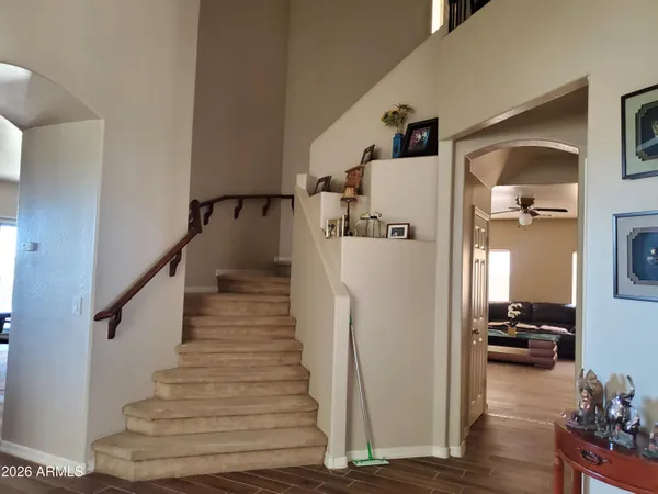 a view of a livingroom with wooden floor and stairs