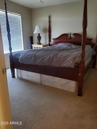 a bedroom with a bed and window