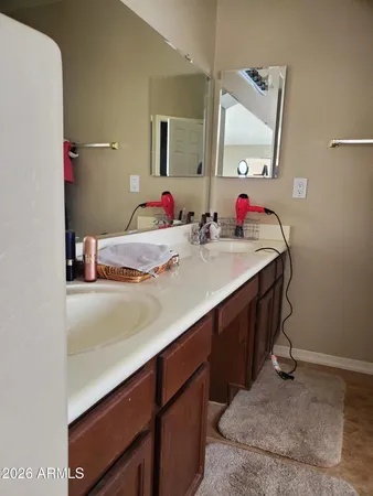 a bathroom with a sink vanity and mirror