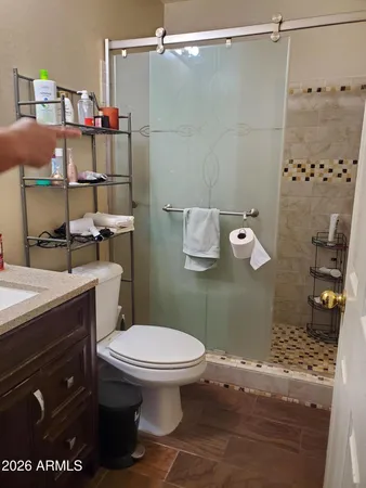 a bathroom with a toilet and a shower