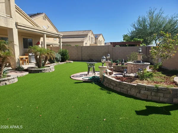 a view of a house with backyard and sitting area