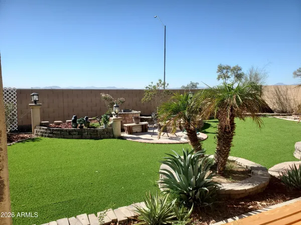 a view of a backyard with plants and patio