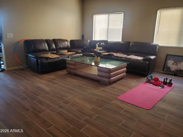 a living room with furniture window and a wooden floor