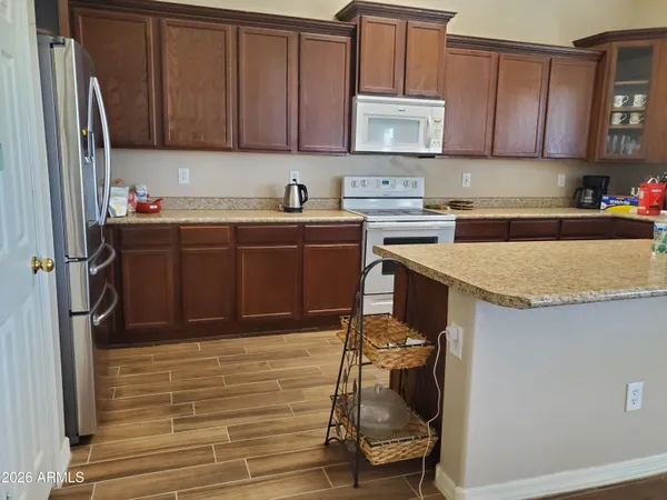 a kitchen with stainless steel appliances granite countertop a refrigerator sink and cabinets