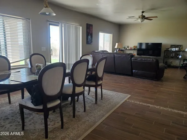 a living room with furniture a chandelier and a window