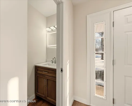 a kitchen with a sink and a mirror