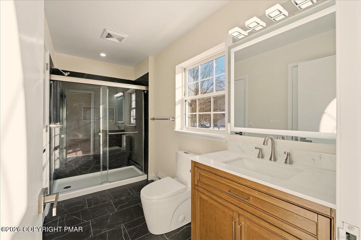 167 Bull Run Long Pond, PA 18334 - Photo 17 of 35 a bathroom with a sink a toilet a mirror and shower