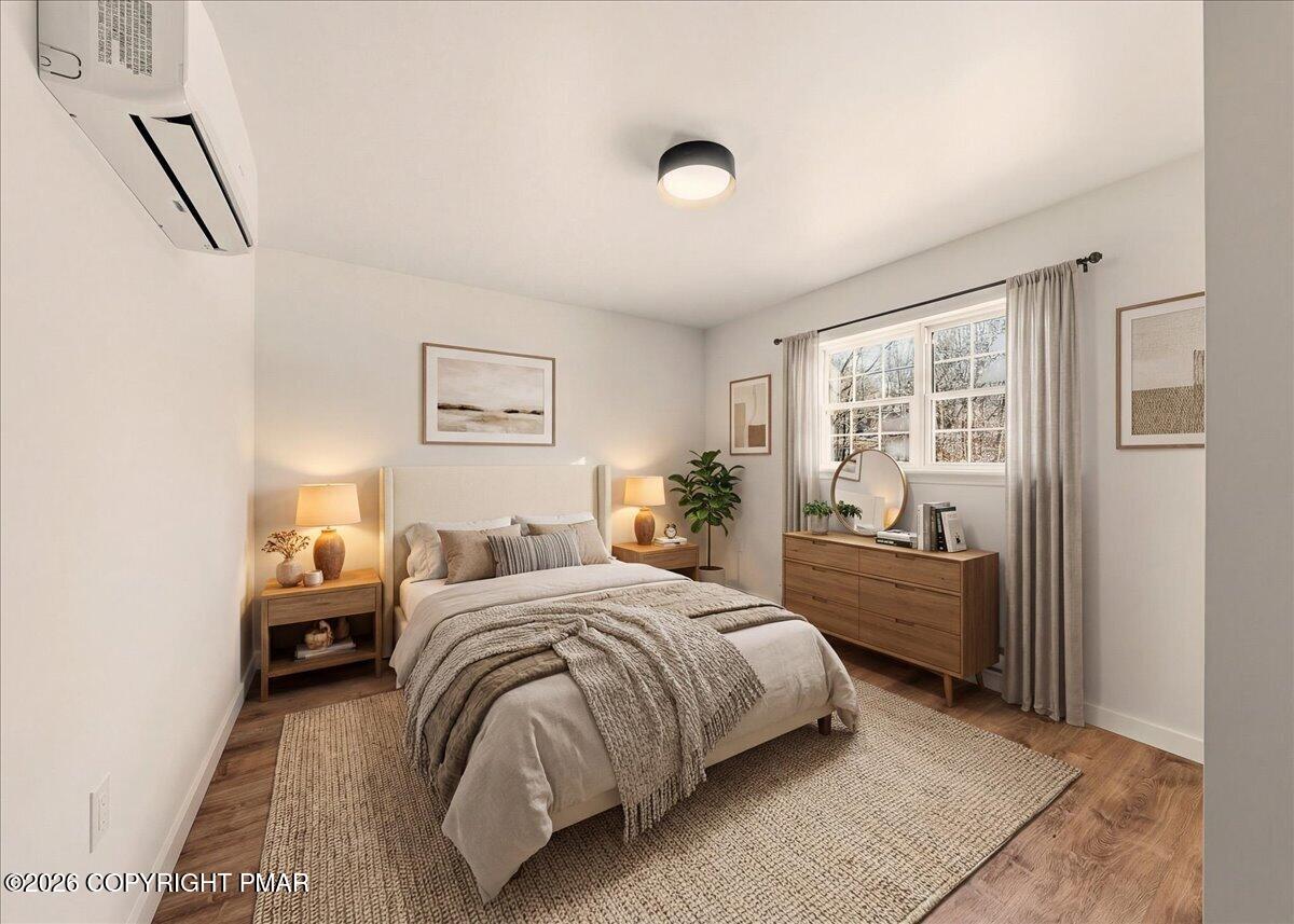 167 Bull Run Long Pond, PA 18334 - Photo 18 of 35 a bedroom with a bed and wooden floor