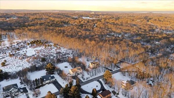 an aerial view of residential houses with city view
