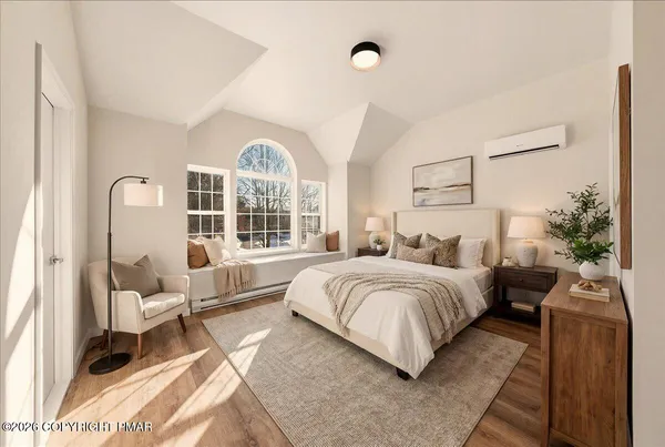 a spacious bedroom with a bed and a large window