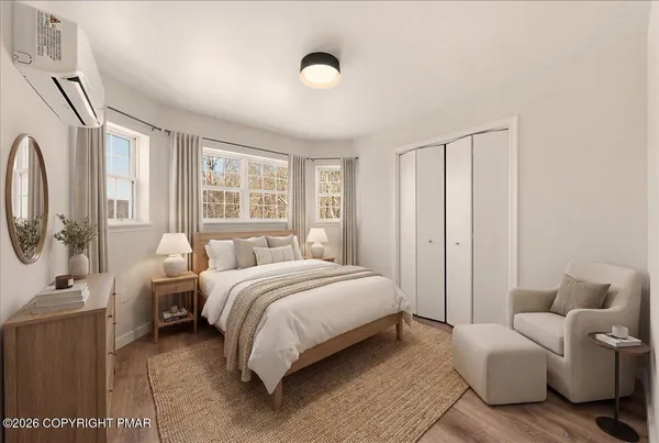 a spacious bedroom with a bed and large windows